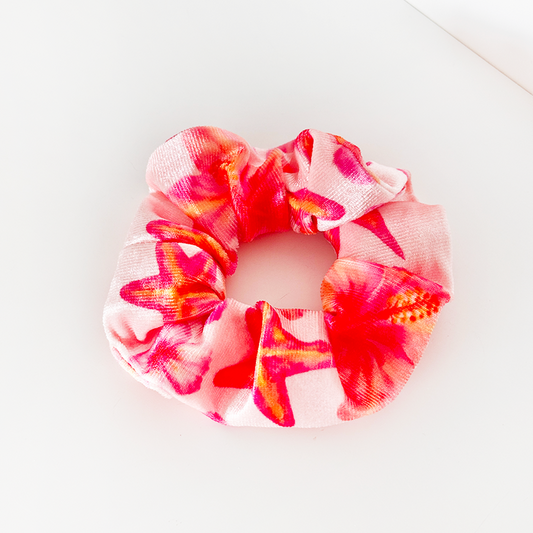 Coconut Lane pink hibiscus scrunchie with vibrant pink and red tie-dye pattern.