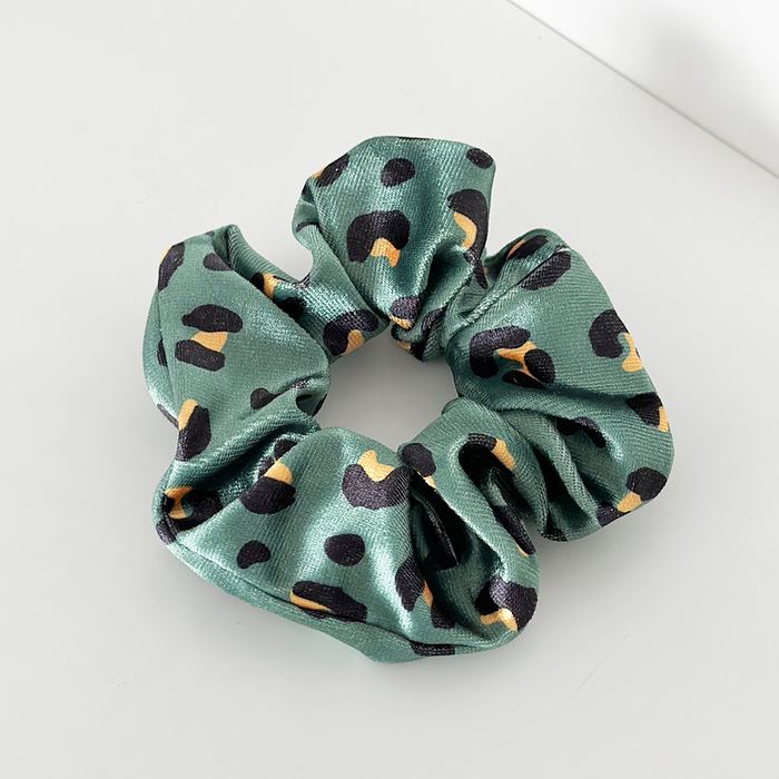 Green satin scrunchie with black and yellow leopard print pattern.