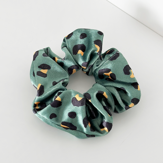 Green satin scrunchie with black and yellow leopard print pattern.
