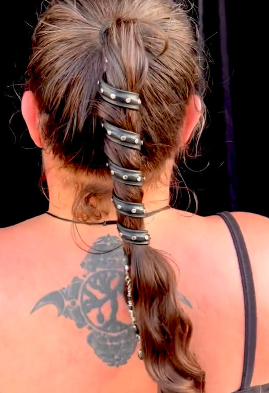 Black leather spiral hair twister ponytail wrap with silver rivets, back view worn in hair