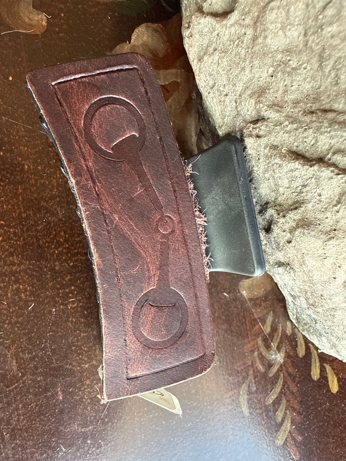Brown leather hair claw with snaffle bit stamping and metal comb teeth