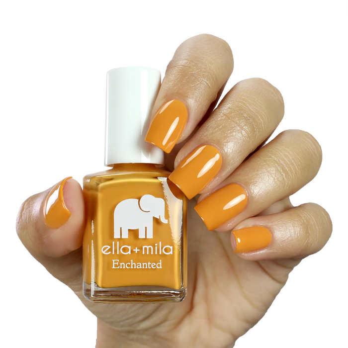 Lost City mustard yellow nail polish manicure on a light skin tone with the bottle