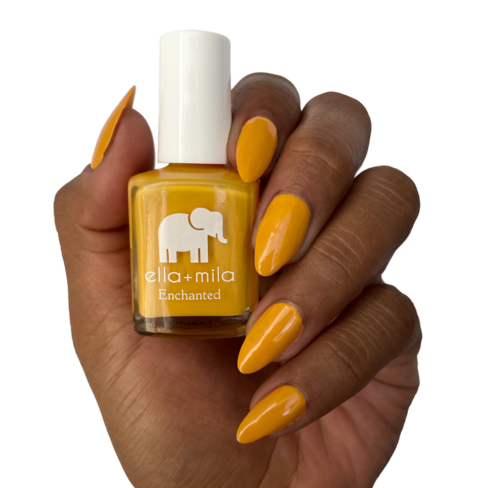 Lost City rustic mustard nail polish on a deep skin tone, holding the bottle