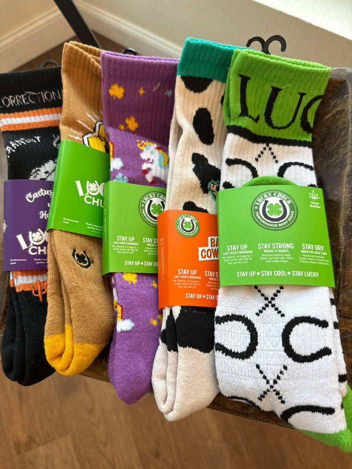 Assorted Lucky Chuck performance socks lineup with multiple prints, including green, tan, and purple.
