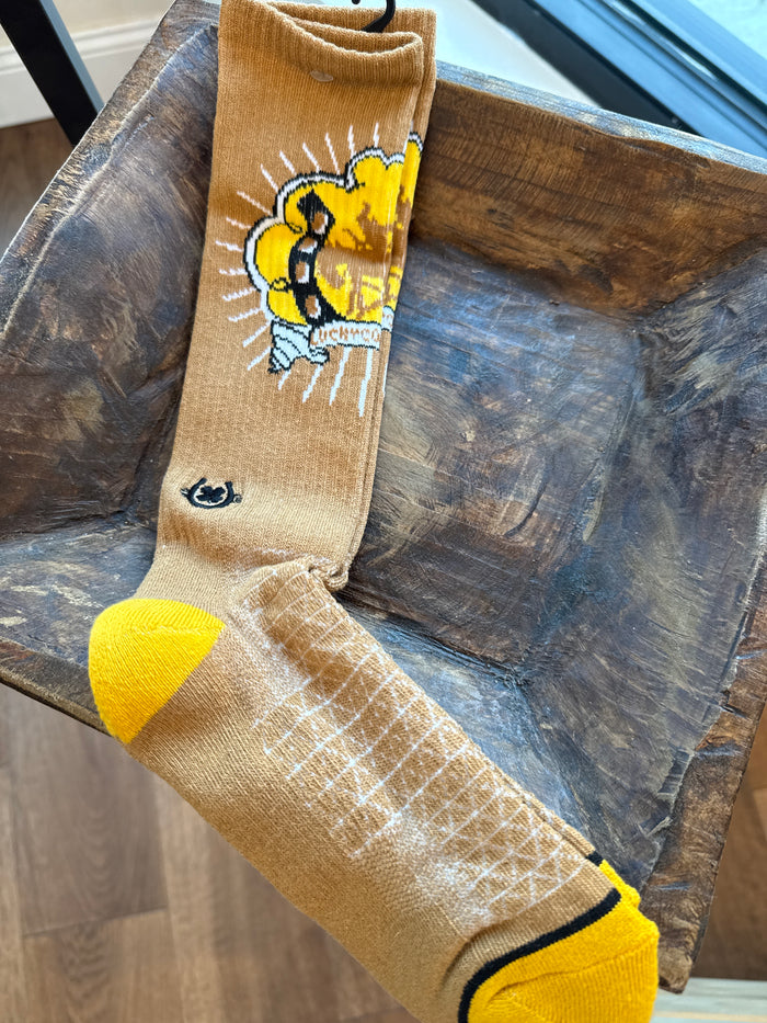 Performance socks in tan with yellow toe/heel and a colorful cowboy graphic cuff.