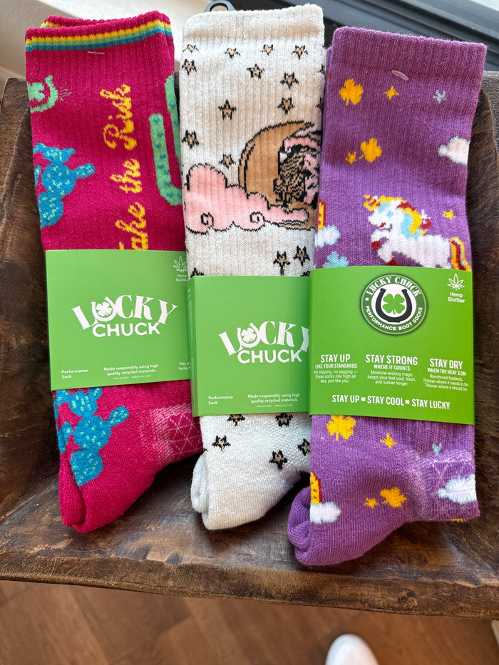 Pack of performance socks: pink, white, and purple with assorted cowboy motifs and stars.