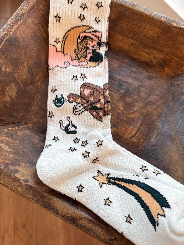 Performance socks in white with rainbow, clouds, cactus icons, and small star accents.