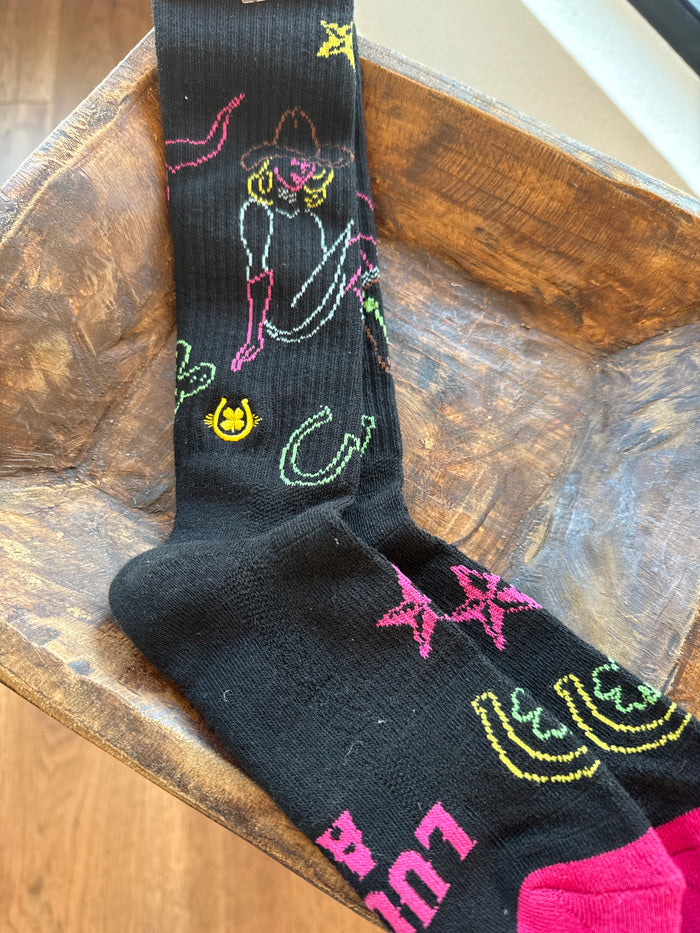 Performance socks in dark gray with bright outlined cowboy/cactus graphics and yellow toe/heel.