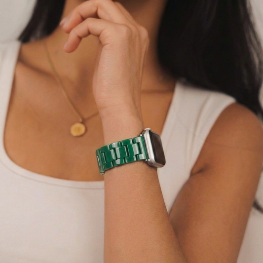 Woman in white tank top and gold necklace with a green Coconut Lane Luxe Apple Watch strap on her wrist.