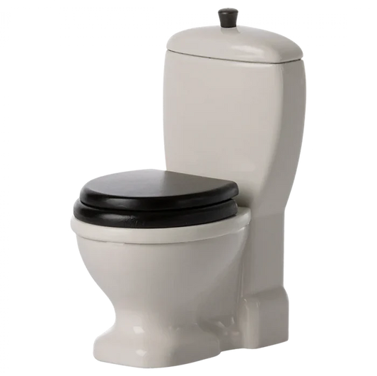 A small, toy-sized off-white colored mouse toilet with a black seat, designed for play and fits the Maileg mice figures.
