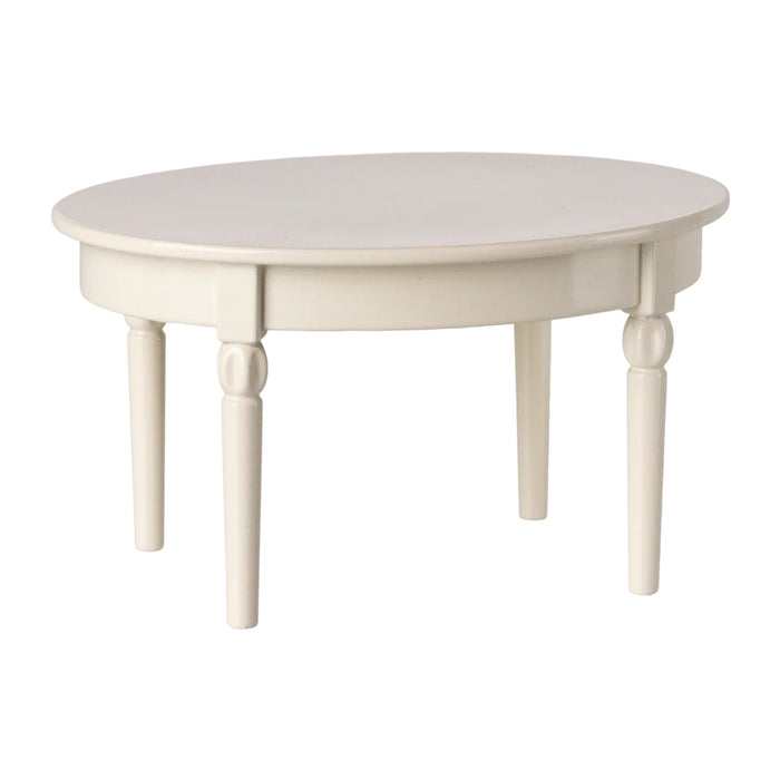 Round white table with four legs on a white background