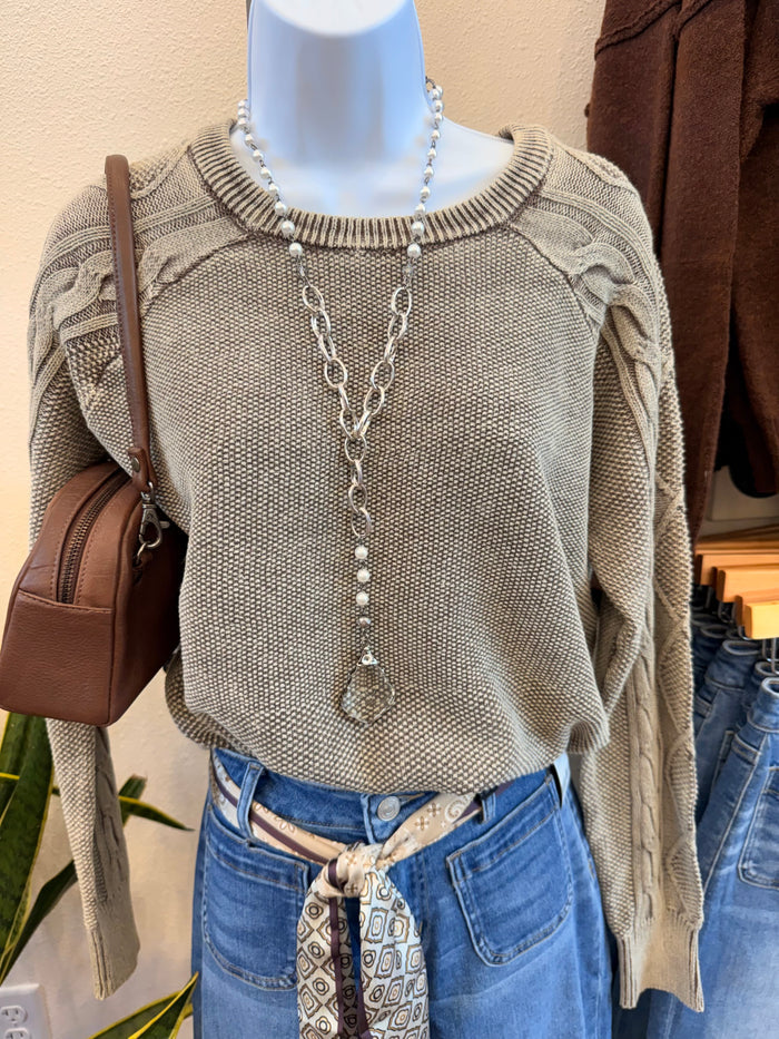 Mocha cable knit crew neck sweater on mannequin, long sleeves with textured stitch pattern