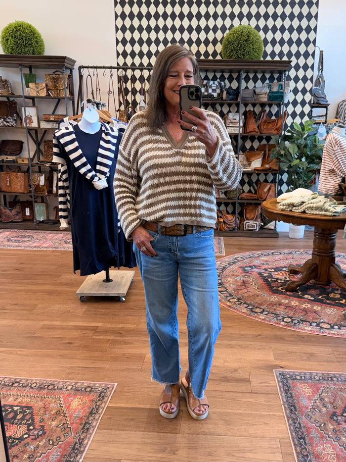 Mocha-and-cream striped loose knit sweater with crew neck and raw-edged hem