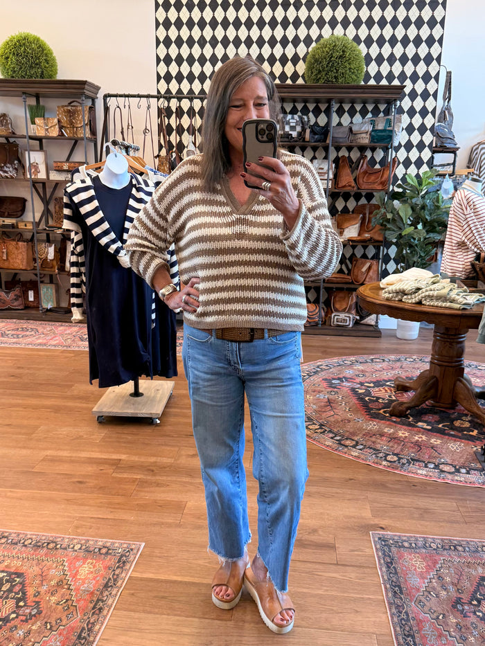 Mocha-and-cream striped loose knit sweater with raw-edged hem and long sleeves