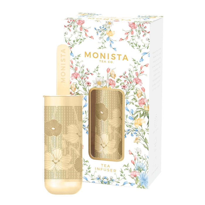 Gold tea infuser with floral packaging featuring the brand 'Monista Tea Co'.