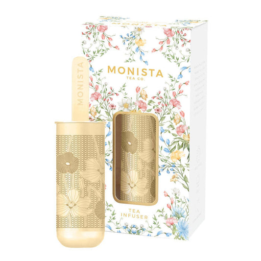 Gold tea infuser with floral packaging featuring the brand 'Monista Tea Co'.