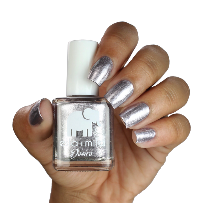 Moonshadow metallic silver nail polish on a medium skin tone, hand holding the bottle