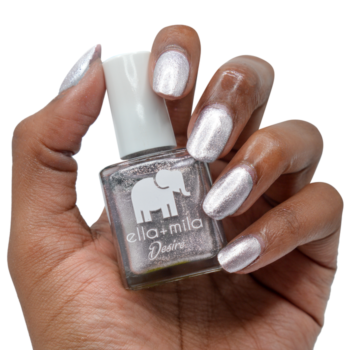 Moonshadow metallic silver nail polish on a deep skin tone, hand holding the bottle