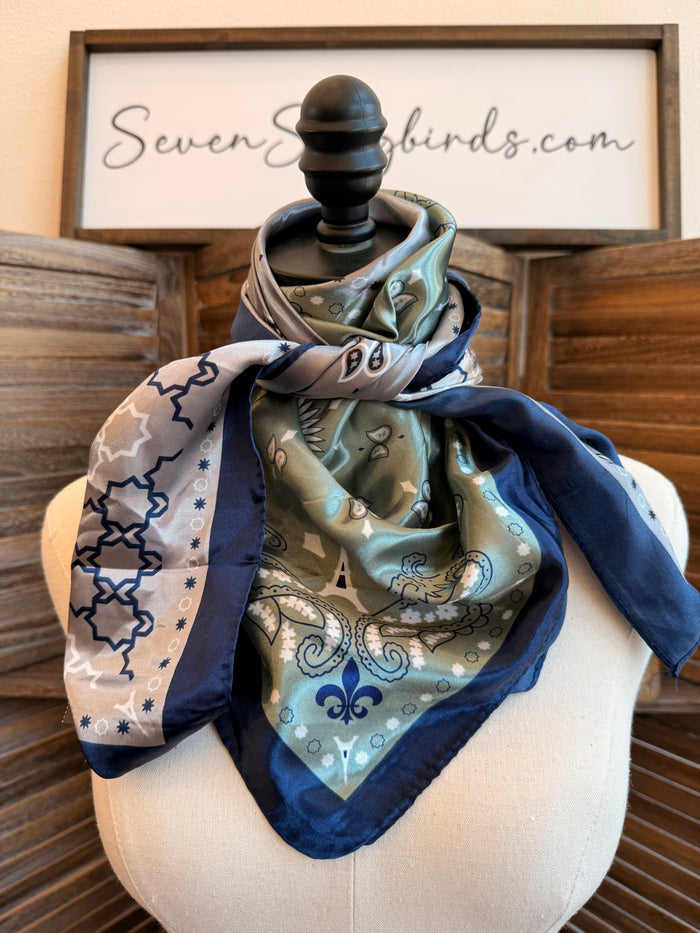 Wild rag scarf draped on mannequin, blue and cream geometric paisley print