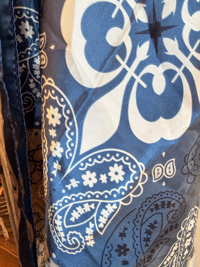 Wild rag scarf with large blue circular and paisley motifs on light background