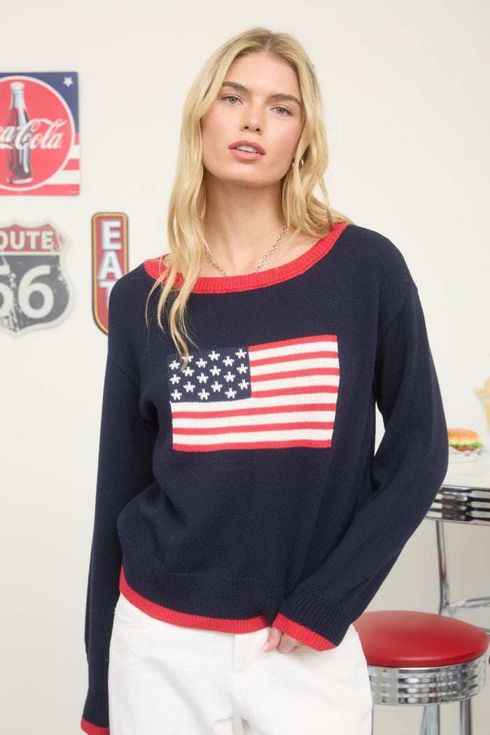 Navy flag graphic sweater with red crew neckline and long sleeves
