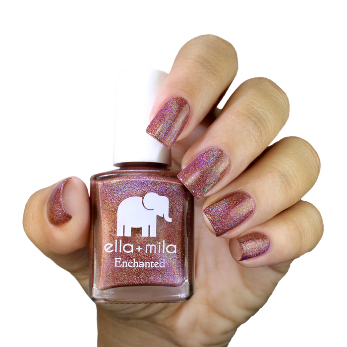 Oasis red orange holographic nail polish manicure on a light skin tone with the bottle