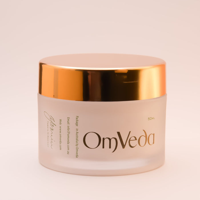 OmVeda brightening night cream jar with back label, gold lid