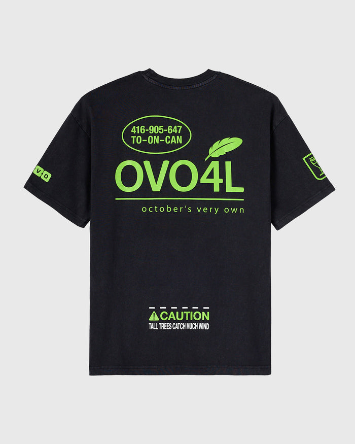 Black t-shirt with neon green OVO4L graphic, phone number, feather icon, and caution text on front and sleeves.