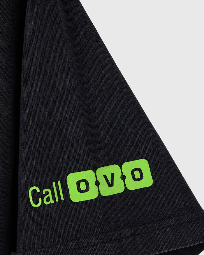 Black t-shirt with ribbed texture and neon green "Call OVO" graphic on lower front.