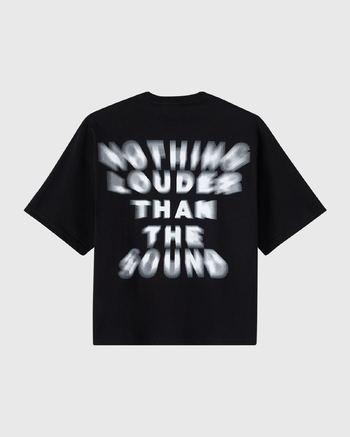 Black t-shirt with white blurred text reading "Nothing Louder Than The Sound" across the chest.