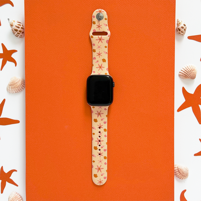 Orange Apple Watch strap with white starfish and seashell pattern from Coconut Lane.