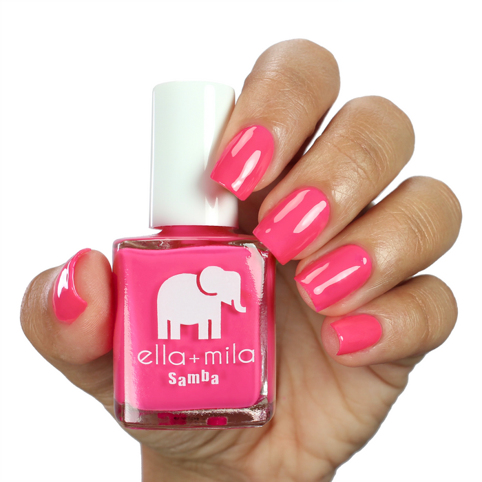 Pink Lemonade magenta pink nail polish on a medium skin tone, hand holding the bottle