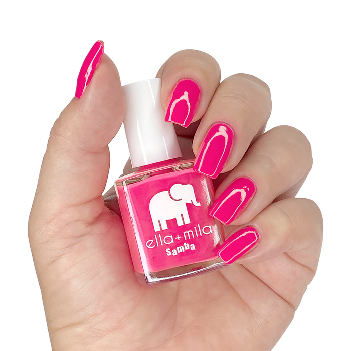 Pink Lemonade magenta nail polish manicure on a light skin tone with the bottle