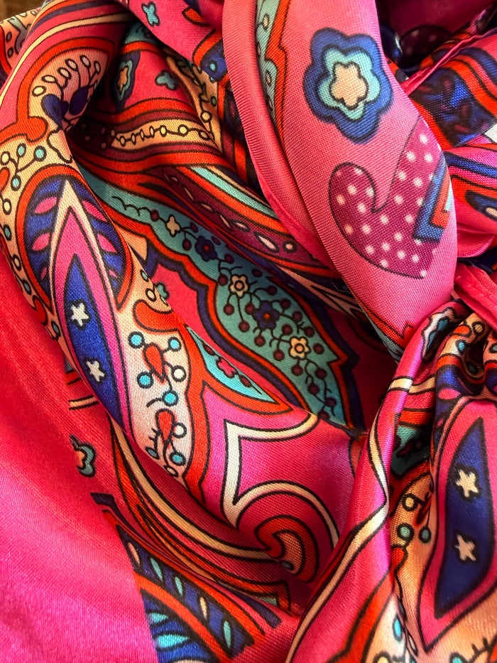 Pink wild rag scarf knot detail with paisley prints and blue accents