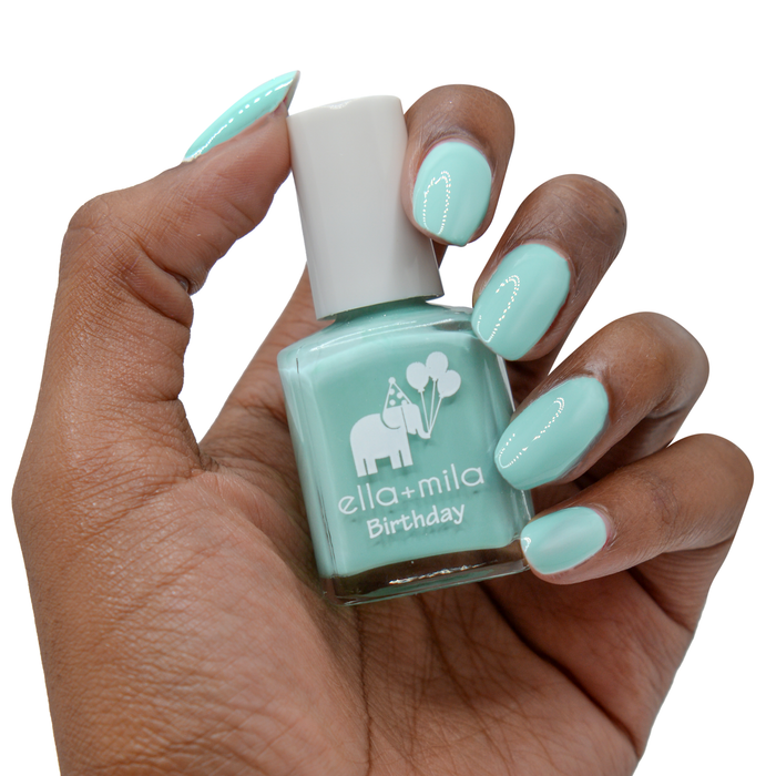 Plead the Fifth pastel turquoise nail polish on a deep skin tone, hand holding the bottle
