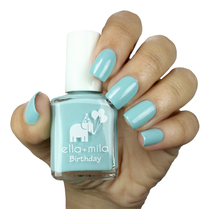 Plead the Fifth pastel turquoise nail polish on a medium skin tone, hand holding the bottle