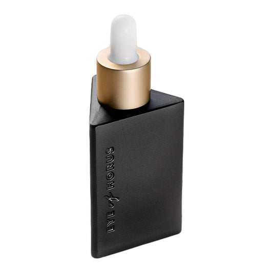 Black and gold dropper bottle with Eye of Horus embossed in the bottle. White background.