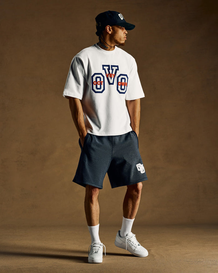 Navy reverse French terry sweatshort with embroidered logo on thigh.