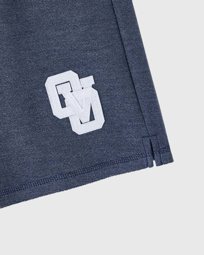 Royal navy reverse French terry sweatshort with white geometric logo patch on thigh.