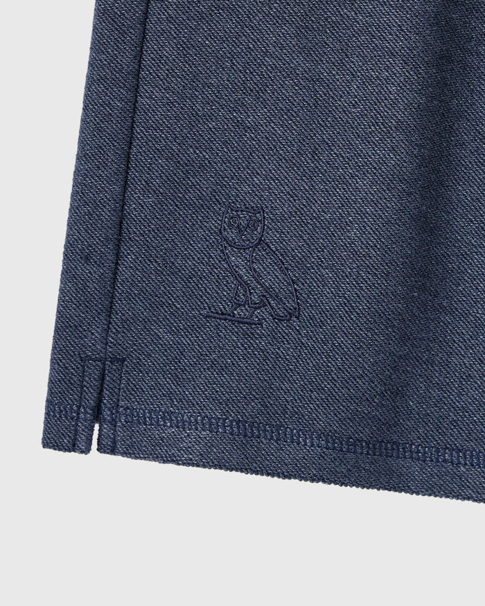 Royal navy sweatshort with embroidered cat graphic and ribbed hem detail.
