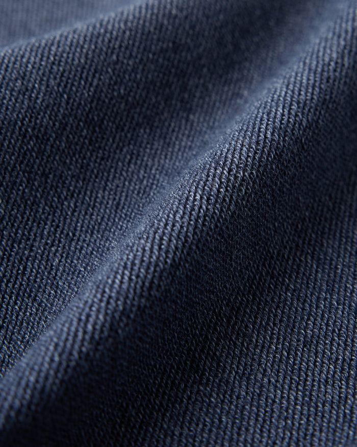 Close-up of royal navy reverse French terry fabric showing textured ribbed weave.