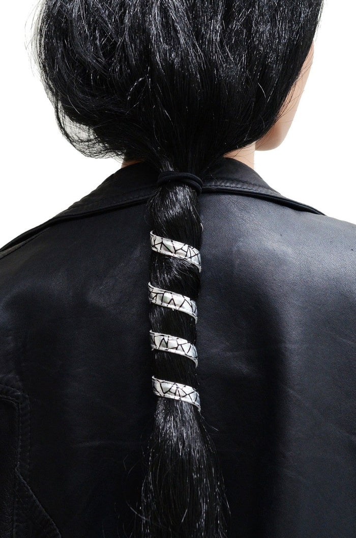 Model wearing 6 inch holographic silver faux leather ponytail wrap, spiral design, back view in ponytail