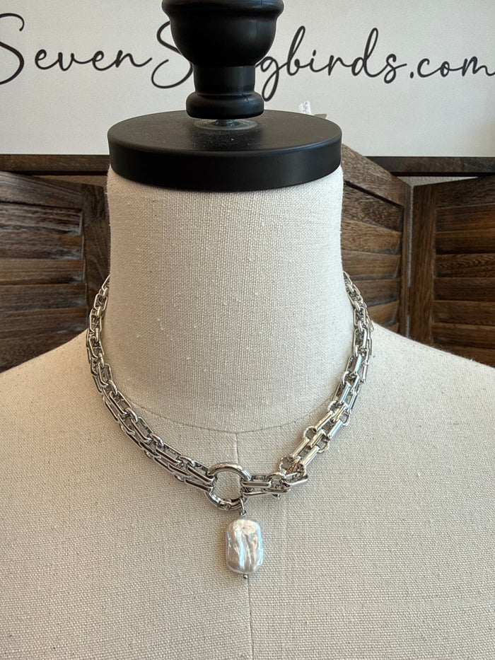 Silver chunky chain necklace with a single white pearl pendant on a thin cord