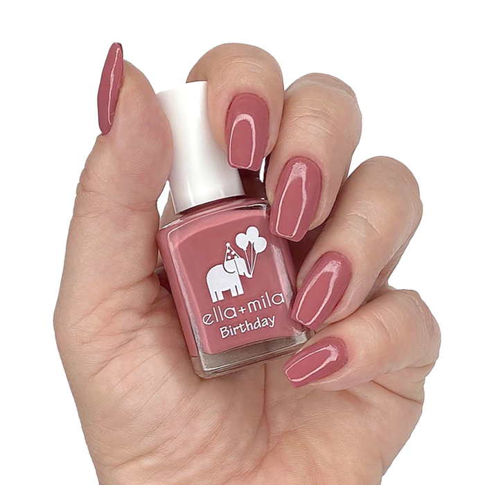Sixth Fix salmon pink nail polish manicure on a light skin tone with the bottle
