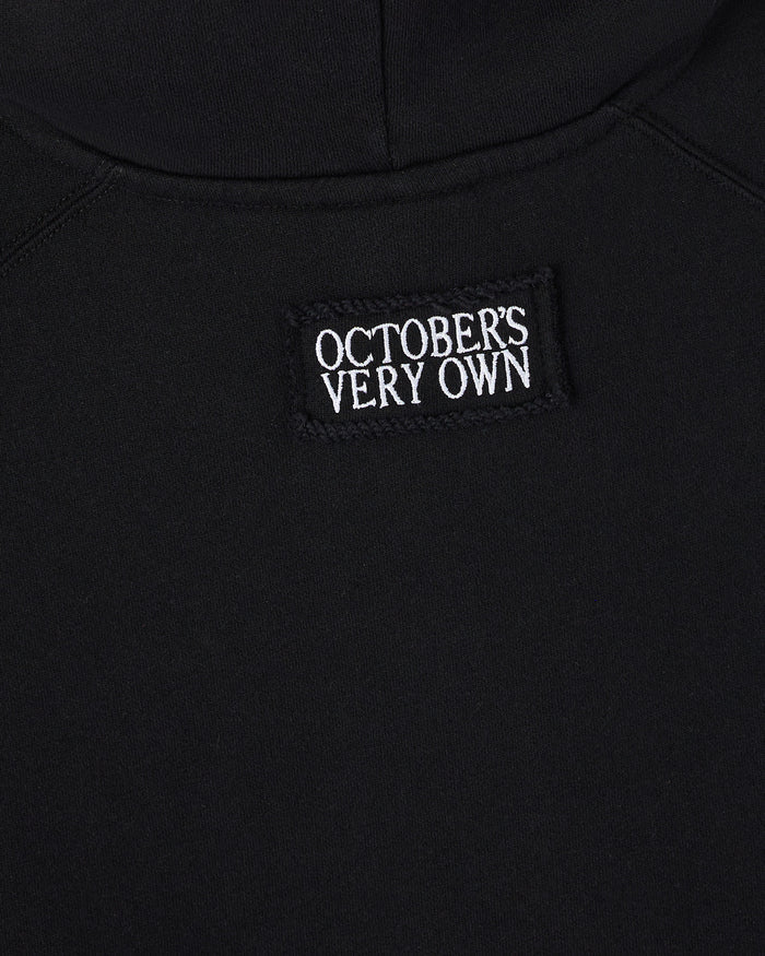 Black sleeveless hoodie with white "October's Very Own" text label on chest.