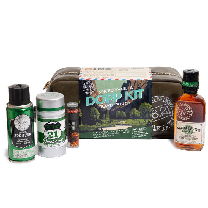 Collection of men's grooming products including a DOPP kit, deodorant, lip balm, travel size wash and cologne on a white background.