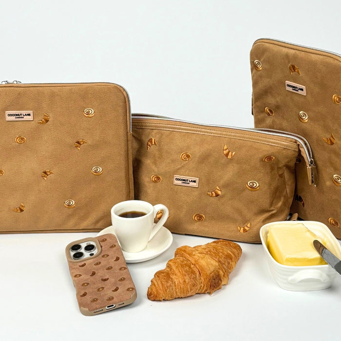 Tan suedette laptop sleeve and matching pastry-shaped pouches on a white background.