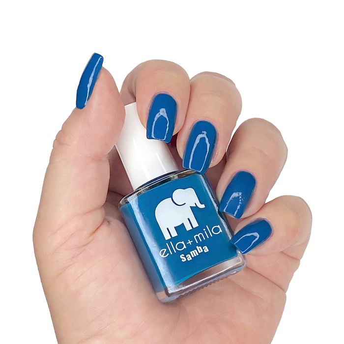 Summertime Sadness cobalt blue nail polish manicure on a light skin tone with the bottle