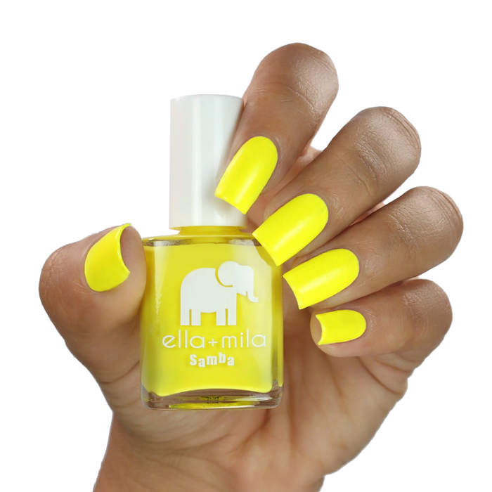 Sunburst vibrant yellow nail polish on a medium skin tone, hand holding the bottle