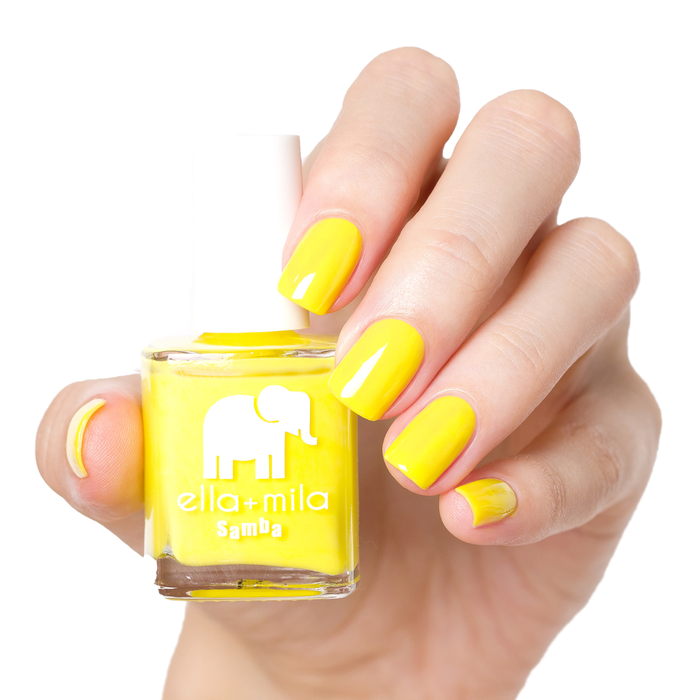 Sunburst sunshine yellow nail polish manicure on a light skin tone with the bottle